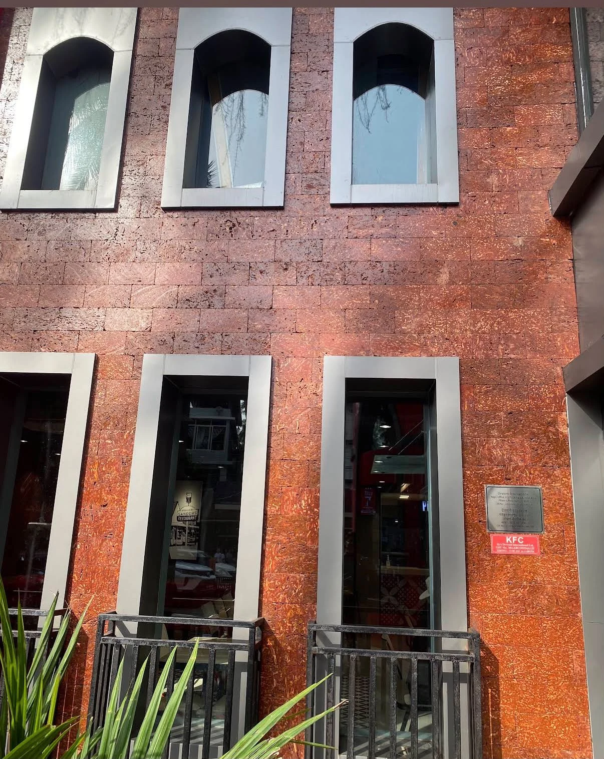Natural laterite stone façade with red-brown texture